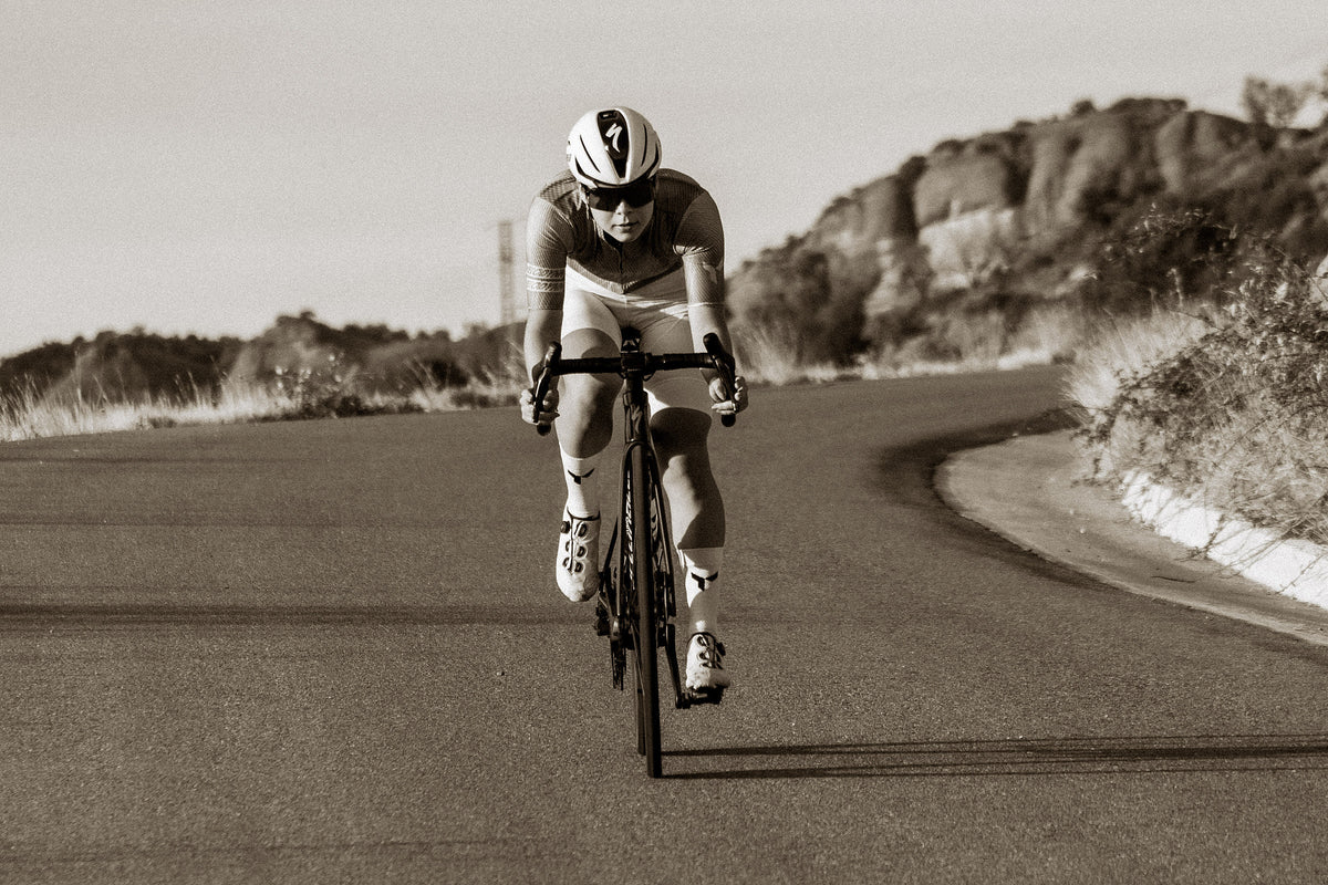 Rider on an empty mountain road, in sepia