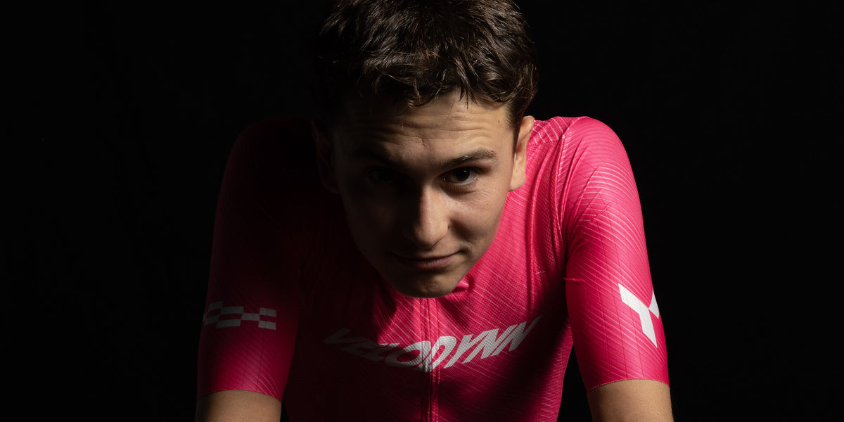 Ciclista con el maillot rosa Ráfaga apoyado en el manillar